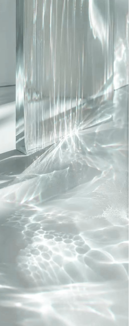Abstract translucent glass surface casting soft rippling light and water-like reflections across a pale white background.