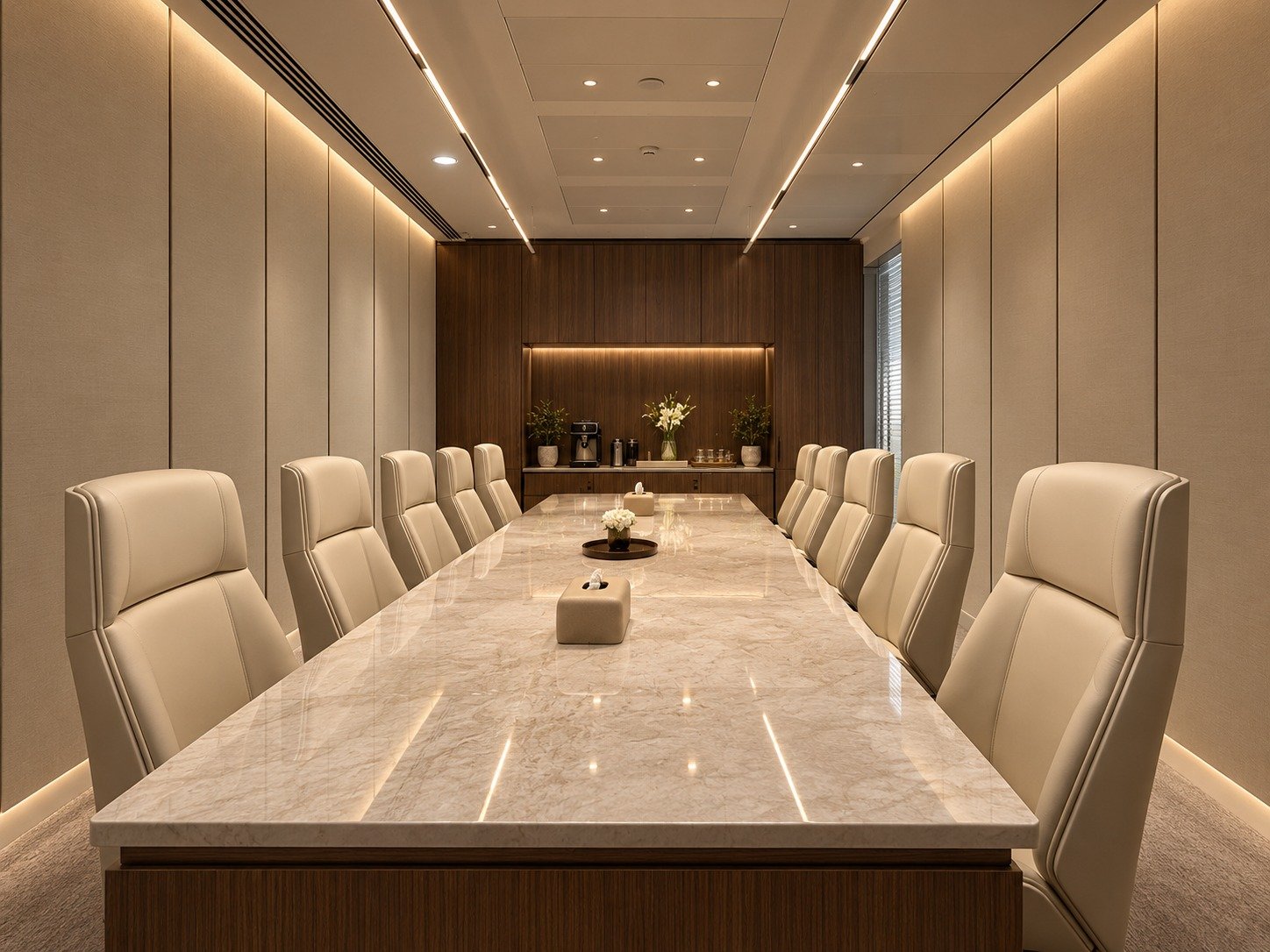Elegant executive boardroom with a polished marble conference table, cream leather chairs, warm wood finishes and sophisticated integrated lighting.